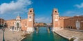 Panoramic view over old Arsenal, statues, clock towers and wooden bridge in Venice, Italy, details, closeup, at blue sky and sunny