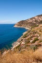 Panoramic view over rocky beach of little village Chiessi and coastal road in autumn at western Elba Island, Italy Royalty Free Stock Photo