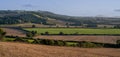 Panoramic view over rolling english countryside at sunset in summer under blue sky Royalty Free Stock Photo