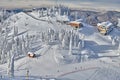 Panoramic view over the ski slope Poiana Brasov ski resort in Transylvania, Pine forest covered in snow on winter season,Mountain