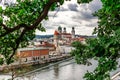 Panoramic view of Passau. View through tree branches. Aerial skyline of old town with beautiful reflection in Danube