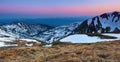 Panoramic view of the peacks of high mountains covered with snow, meadow with the rocks, amazing sunrise. Eco resort Carpathians.