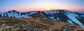 Panoramic view of the picks of high mountains covered with snow, meadow with the rocks, amazing sunrise. Eco resort Carpathians.