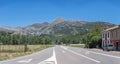 Panoramic view at the Picos de Europa, Peaks of Europe, road, houses, agriculture fields and mountain range extending