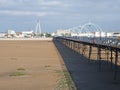 A panoramic view of the pier in southport merseyside with the beach at low tide on a bright summer day with the suspension bridge Royalty Free Stock Photo