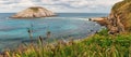 Panoramic view of Playa de Covachos beach in Santander, Cantabria, North Spain with rocky island and sandy spit. Popular