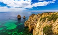 Panoramic view, Ponta da Piedade near Lagos in Algarve, Portugal. Cliff rocks and tourist boat on sea at Ponta da Piedade, Algarve