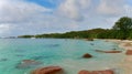 Popular Anse Lazio beach with docking boats, tourists enjoying their vacation and turquoise colored water on Praslin, Seychelles. Royalty Free Stock Photo