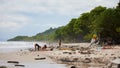 Panoramic view of a populated beach of Santa Teresa, with people having rest on the beach