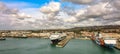 Panoramic view of port of Civitavecchia. Cruise ships, cargo ships and tourist ferries stand in harbor