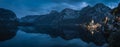 Panoramic view at the postcard angle of Hallstatt town at dusk after sunset with lake foreground and reflection