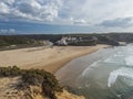 Panoramic view of Praia de Odeceixe Mar Surfer beach with golden sand, atlantic ocean waves, river bend and white houses Royalty Free Stock Photo
