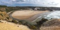 Panoramic view of Praia de Odeceixe Mar Surfer beach with golden sand, atlantic ocean waves, river bend and white houses Royalty Free Stock Photo