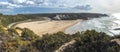 Panoramic view of Praia de Odeceixe Mar Surfer beach with golden sand, atlantic ocean waves, river bend and white houses of Royalty Free Stock Photo
