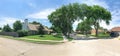 Panoramic view quite neighborhood with tall trees canopy, pathway and single family houses Royalty Free Stock Photo