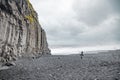 Panoramic view of Reynisfjara beach cave in Iceland with big basalt pillars and rocky beach. Cold windi place at the beach with