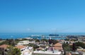 Panoramic view of rhodes town with buildings of the city and old walls around the harbor with ships and boats next to a blue Royalty Free Stock Photo