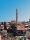 Panoramic view of rhodes town with the dome and minaret of the Suleiman mosque and city buildings against a blue summer sky Royalty Free Stock Photo