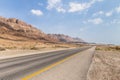 Panoramic view of the road, coast of Dead Sea and mountains in the Judean Desert in the Dead Sea region in Israel