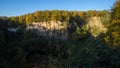 Panoramic view of the rock wall of the Weilbergsee with autumn forest in the evening light. Royalty Free Stock Photo