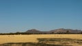 Panoramic of rolling farm fields of freshly harvested hay on rural properties in Victoria with part of the Grampians National Royalty Free Stock Photo