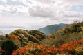 Panoramic View of Rolling Hills and Mountains Under Cloudy White Sky Royalty Free Stock Photo