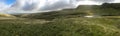 A panoramic view of the rolling vivid green hills and mountains of the Brecon Beacons in Wales with a lake in the foreground Royalty Free Stock Photo