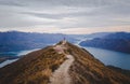 Panoramic view of the Roys Peak in New Zealand with low mountains in the distance under cloudscape