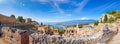 Panoramic View Of Ruins Of Ancient Greek Theatre In Taormina On Background Of Etna Volcano, Italy