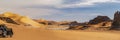 Panoramic view of Sahara Desert 4X4 side part car sand dune and rocky mountain. Royalty Free Stock Photo