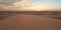 A panoramic view of sand dunes under a pastel sky at sunset creating a serene landscape scene Royalty Free Stock Photo