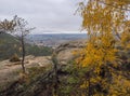 View from sandstone pillars view-point at nature reserve Cesky Raj with autumn colored deciduous and coniferous tree