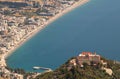 Panoramic view of the sea town, coastal part, and beautiful monastery on the mountain