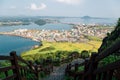 Panoramic view of seaside village from Seongsan Ilchulbong Tuff Cone in Jeju Island, Korea Royalty Free Stock Photo