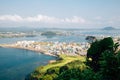 Panoramic view of seaside village from Seongsan Ilchulbong Tuff Cone in Jeju Island, Korea Royalty Free Stock Photo