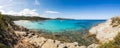 Boats in a small rocky cove with sandy beach in Corsica Royalty Free Stock Photo