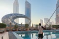 Panoramic view of Sheikh Zayed road with Museum of Future, high-rise towers and swimming pool. Black African American