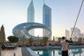 Panoramic view of Sheikh Zayed road with Museum of Future, high-rise towers and swimming pool. Black African American