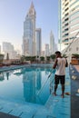 Panoramic view of Sheikh Zayed road with Museum of Future, high-rise towers and swimming pool. Black African American