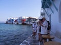 Panoramic view of the sights of the island of Little Venice with walking tourists in Mykonos, Greece. Royalty Free Stock Photo