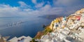 Panoramic view of the sights of Santorini The famous town of Oia in the morning. A line of sailing yachts at sea. Good vacation.