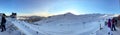 Panoramic view of ski resort, slope, people on the ski lift, skiers on the piste in Valle Nevado