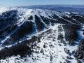 Panoramic view of the ski slope with the mountains and wood. Kopaonic ski resort in Serbia. Royalty Free Stock Photo
