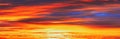 Panoramic View Sky Sunset Sunrise Background. Abstract Saturated Orange-yellow Colors Of Clouds. Unusual Sky Background