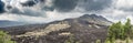 Panoramic view of the slopes of the Batur volcano covered with black lava Royalty Free Stock Photo