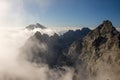 Panoramic view from Slovakia High Tatras Mountain peak Rysy in the foggy summer moring. Highest peak Gerlach covered by clouds