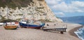 Panoramic view of small fishing boats moored on shingle beach in Beer, Devon, UK