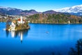 Panoramic view of small natural island in the middle of alpine lake with church dedicated to assumption of Mary and castle Royalty Free Stock Photo