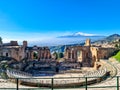 Taormina - Panoramic view of snow capped Mount Etna volcano seen from the ancient Greek theatre of Taormina, island Sicily, Italy Royalty Free Stock Photo