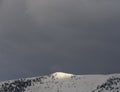 Panoramic view Snow-capped peaks of mount Dirfys spruce forest on a background of black storm clouds on the island of Evia Euboea Royalty Free Stock Photo